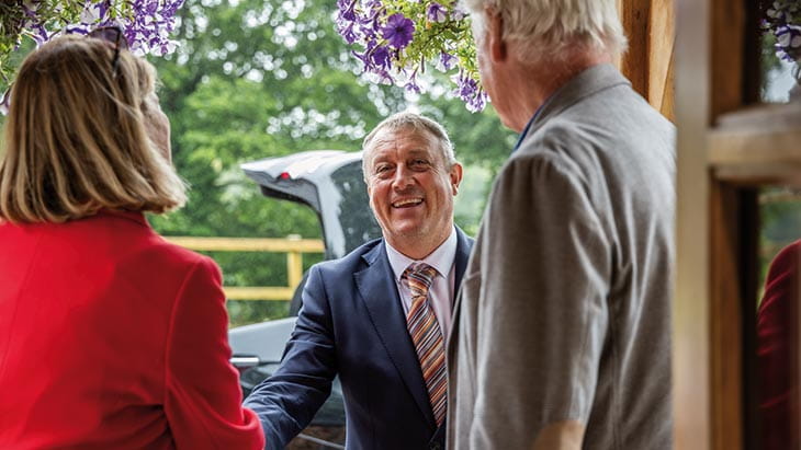 A Saga chauffeur greeting passengers, as they are picked up from their home for their cruise